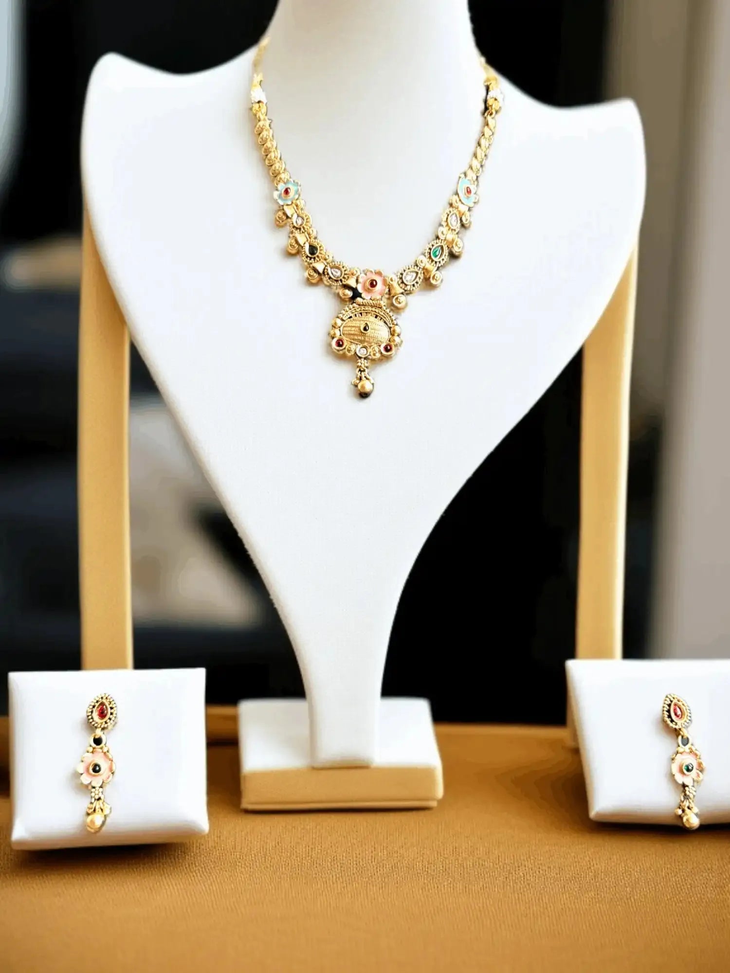 Fashionable Gold Tone Necklace and Earrings Set with Gemstone Accents.