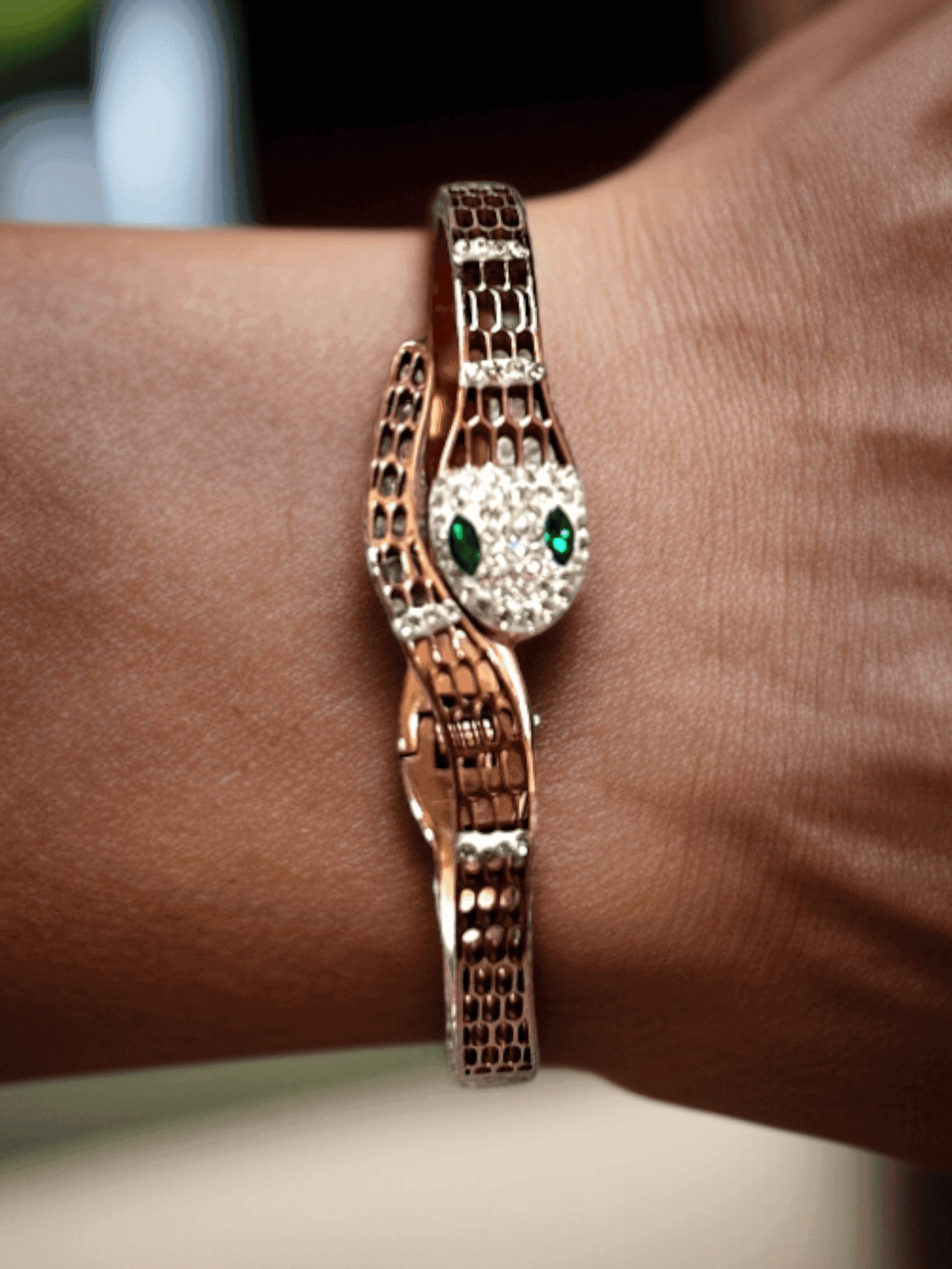 Gleaming Gold Tone Snake Bangle with Green Eyes.