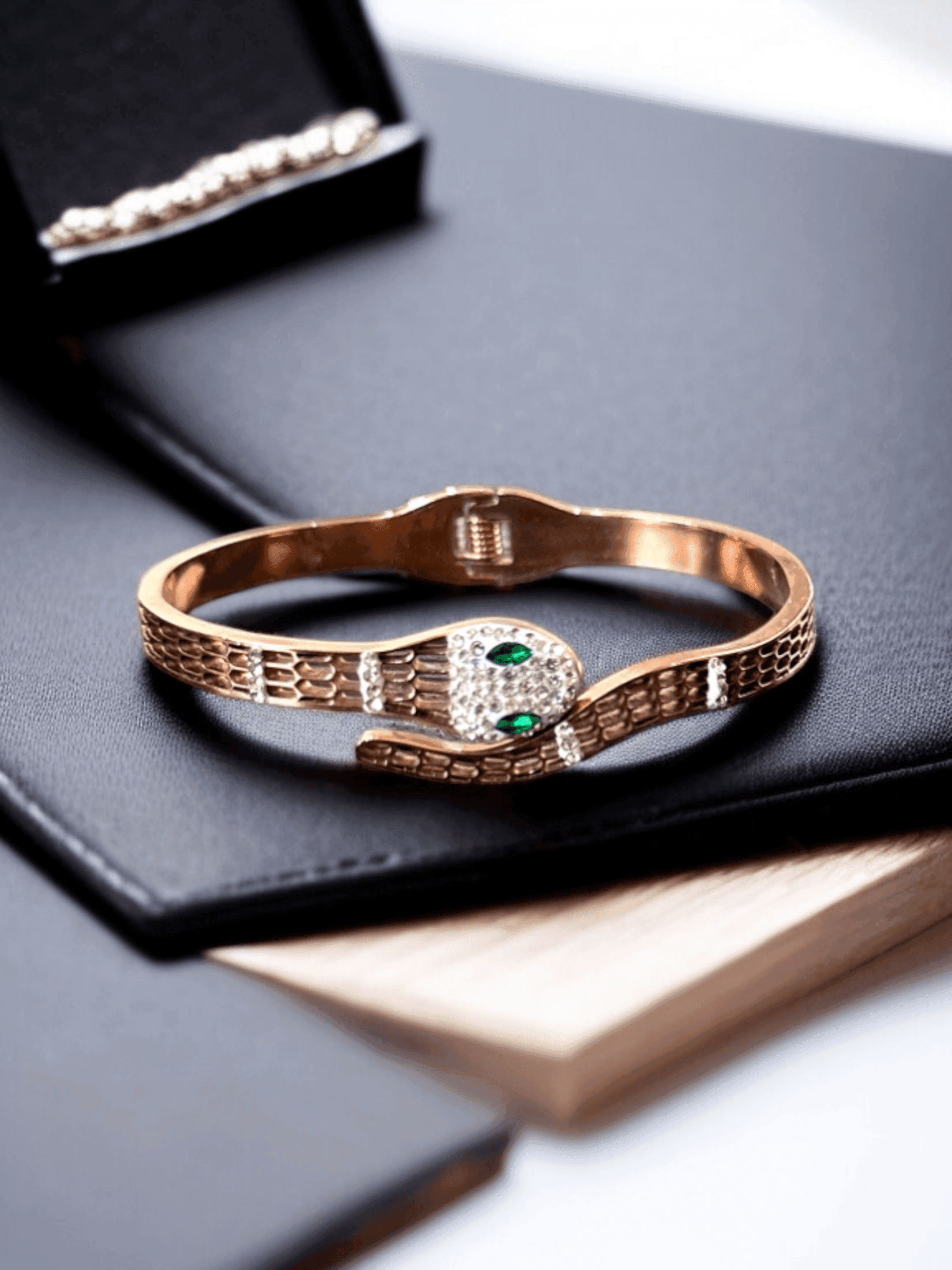 Gleaming Gold Tone Snake Bangle with Green Eyes.