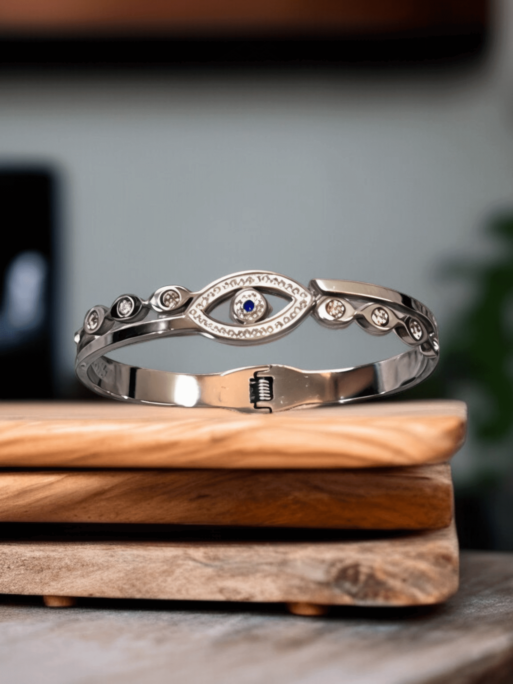 Polished Silver Tone Evil Eye Bangle Bracelet with Royal Blue Center.